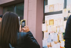 woman in black jacket holding phone