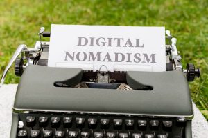 a typewriter with a paper that reads digital nomadism