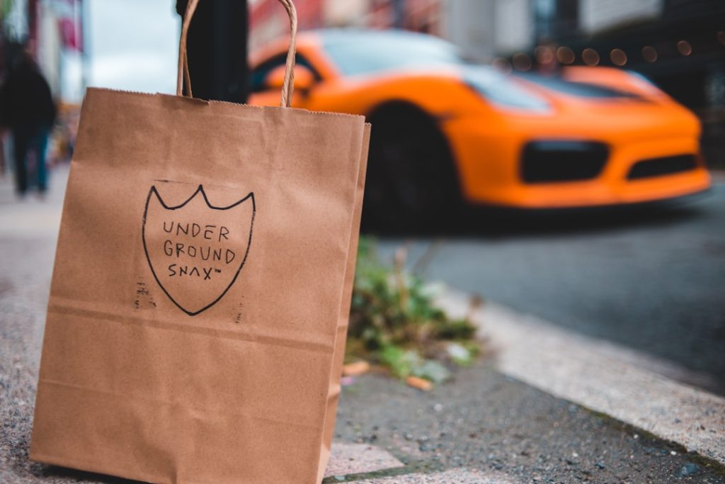 brown paper bag on gray concrete floor