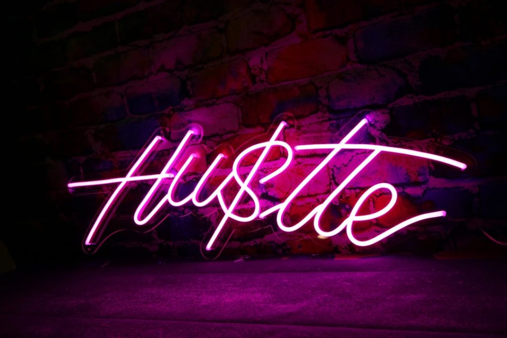 a neon sign on a brick wall