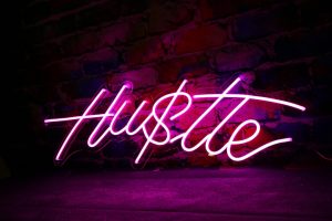 a neon sign on a brick wall