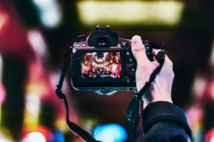 person holding black DSLR camera