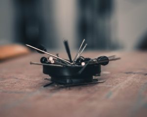 black and silver hair clip on brown wooden table