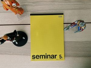 a table with a yellow book and a pair of scissors