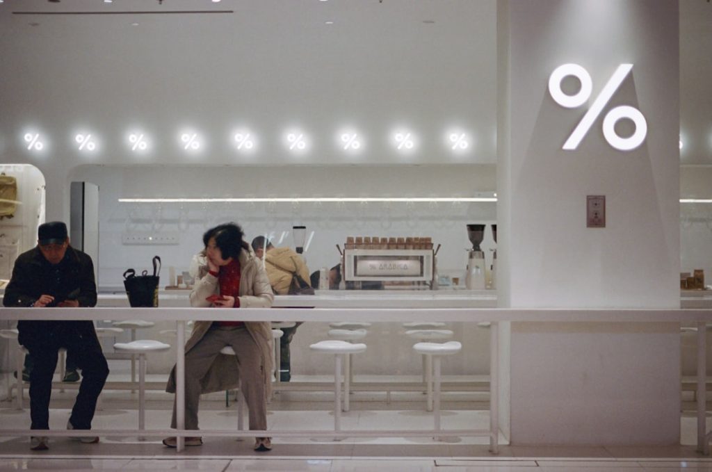A couple of people sitting at a table in a store