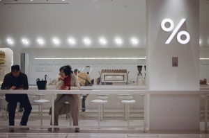 A couple of people sitting at a table in a store